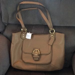 This large coach leather bag is 15 1/2 inches wide by 10” high.